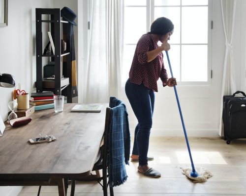 Black woman cleaning room